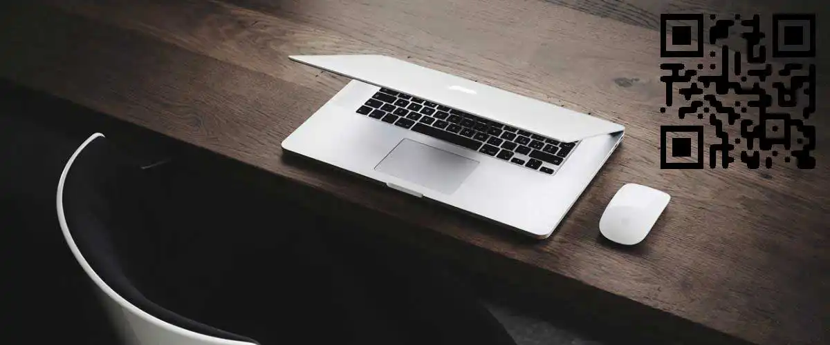QR code marketing next to laptop computer