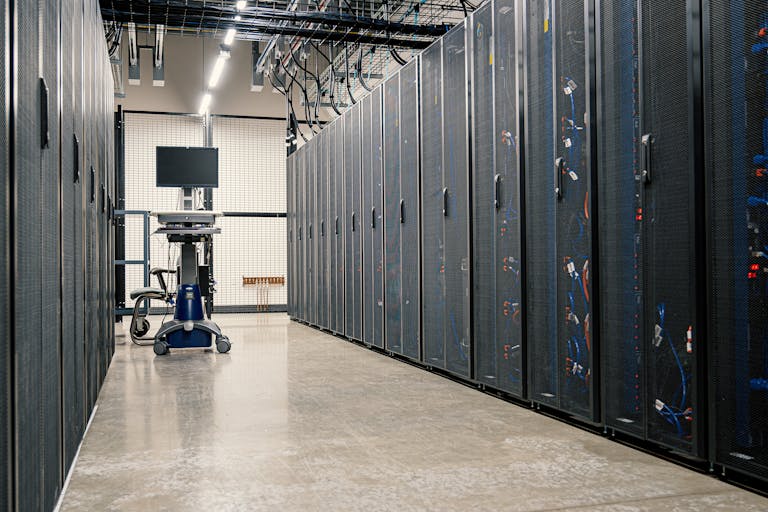 Modern data center corridor with server racks and computer equipment. Ideal for technology and IT concepts.